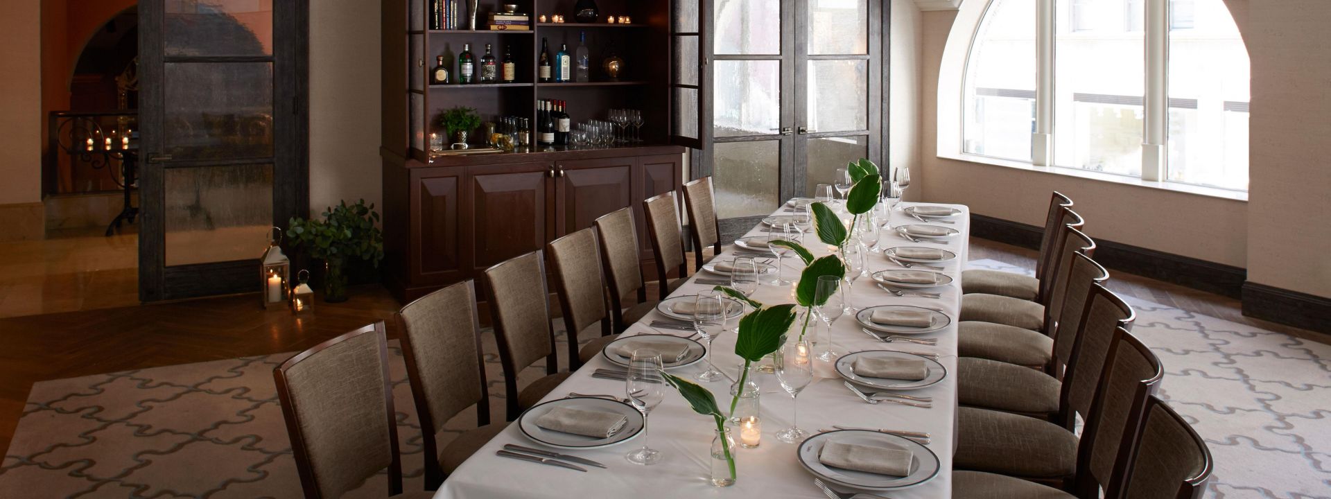 A dining room with 14 place settings at The Benjamin Hotel NYC