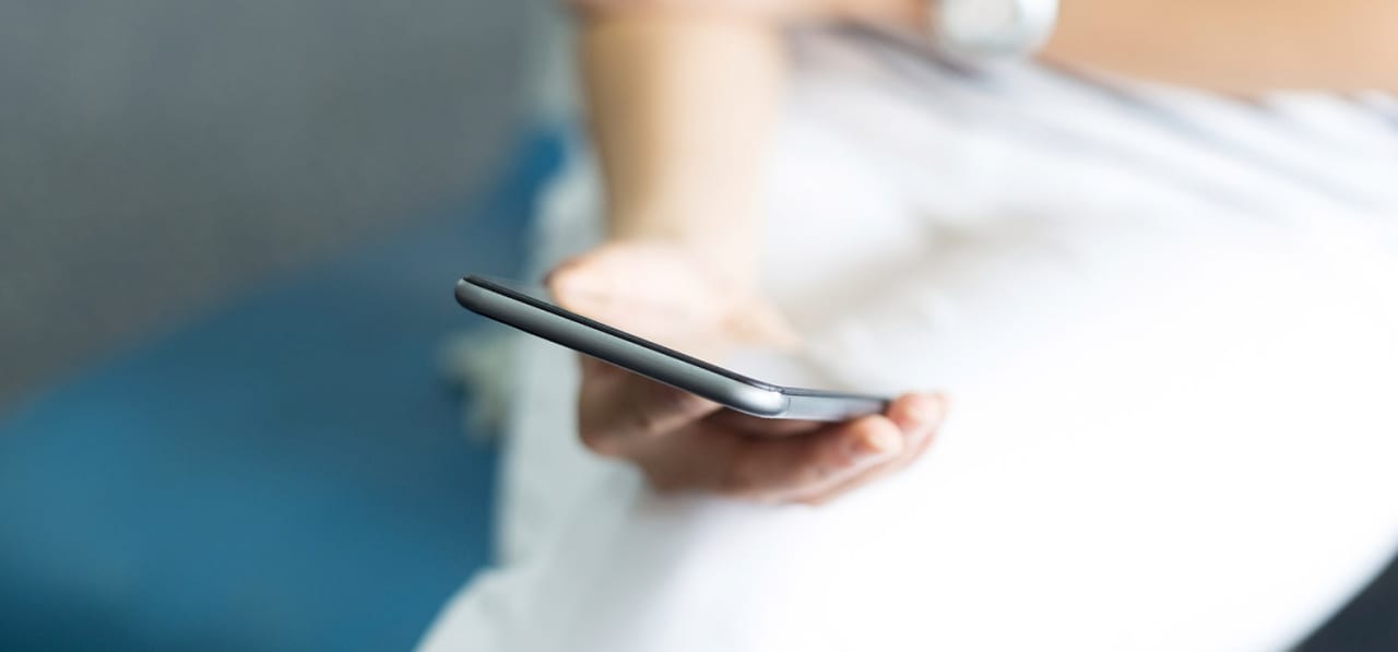 A business professional holding a smart phone