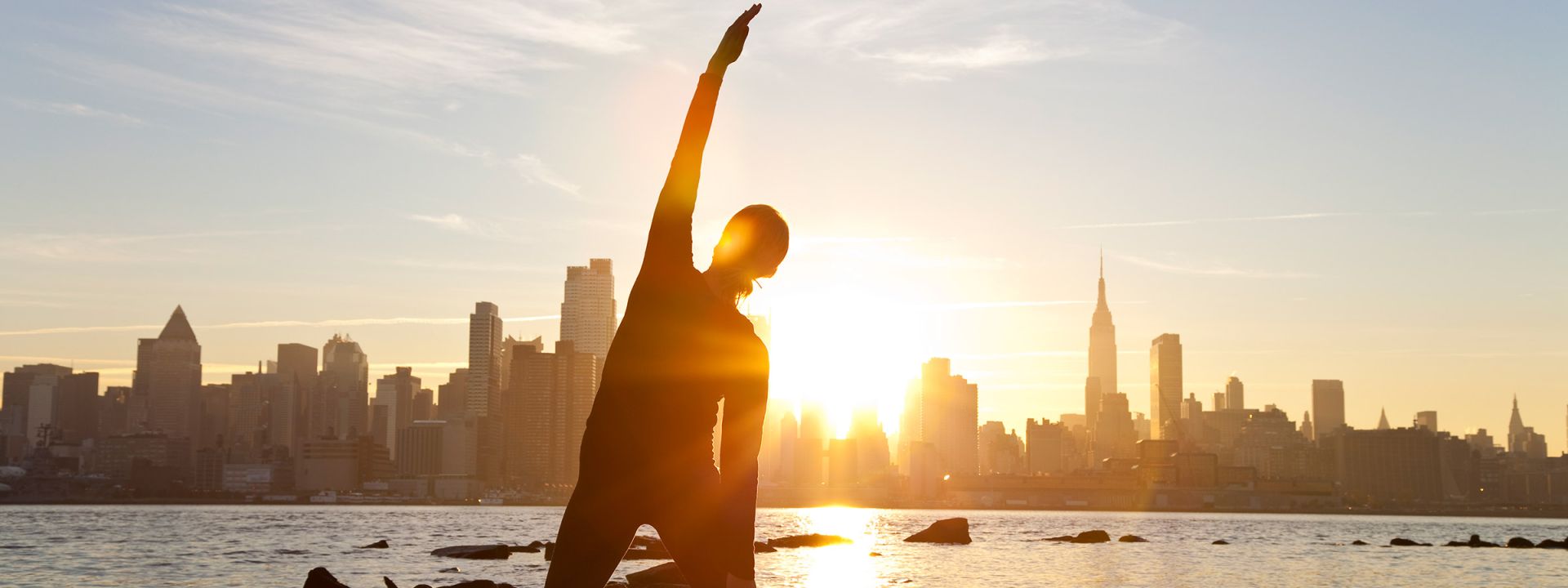 Woman doing yoga with nyc skyline